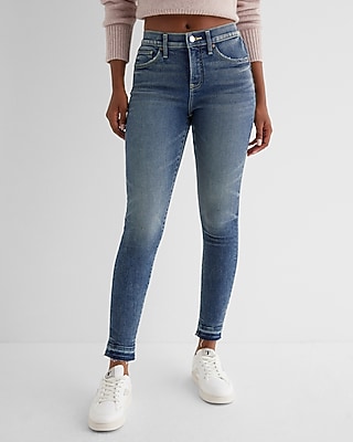 Mid Rise Medium Wash Raw Drop Hem Skinny Jeans