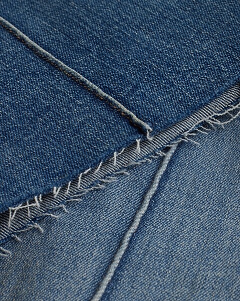 Mid Rise Medium Wash Pintuck Raw Hem Flexx '70s Flare Jeans | Express