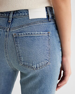 Mid Rise Medium Wash Raw Drop Hem '70s Flare Jeans