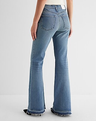 Mid Rise Medium Wash Raw Drop Hem '70s Flare Jeans