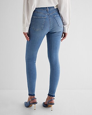 High Waisted Medium Wash Ripped Raw Drop Hem Skinny Jeans