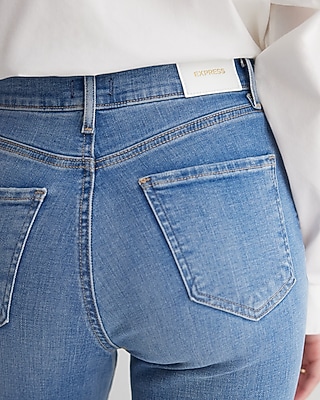 High Waisted Medium Wash Ripped Raw Drop Hem Skinny Jeans