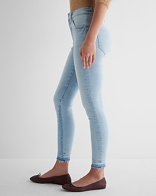 Mid Rise Light Wash Raw Drop Hem Skinny Jeans