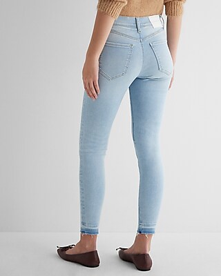 Mid Rise Light Wash Raw Drop Hem Skinny Jeans